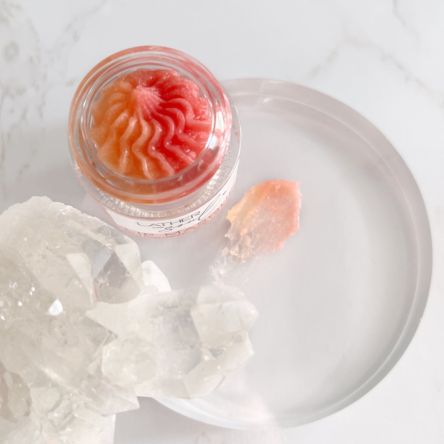 Lip Masque in an Enchanting Setting: Our Hydrating Lip Masque jar takes center stage, drawing attention with its soothing formula and its elegant texture