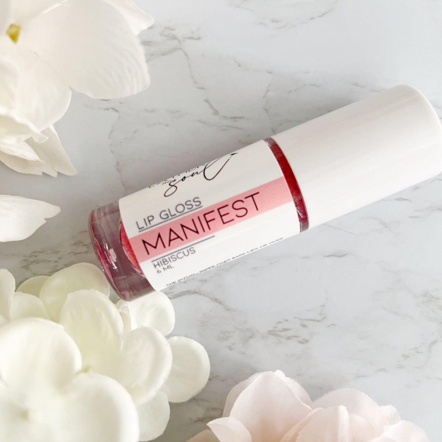 "Manifest" rose gold sheer shimmer lip gloss, from Lather and Soul